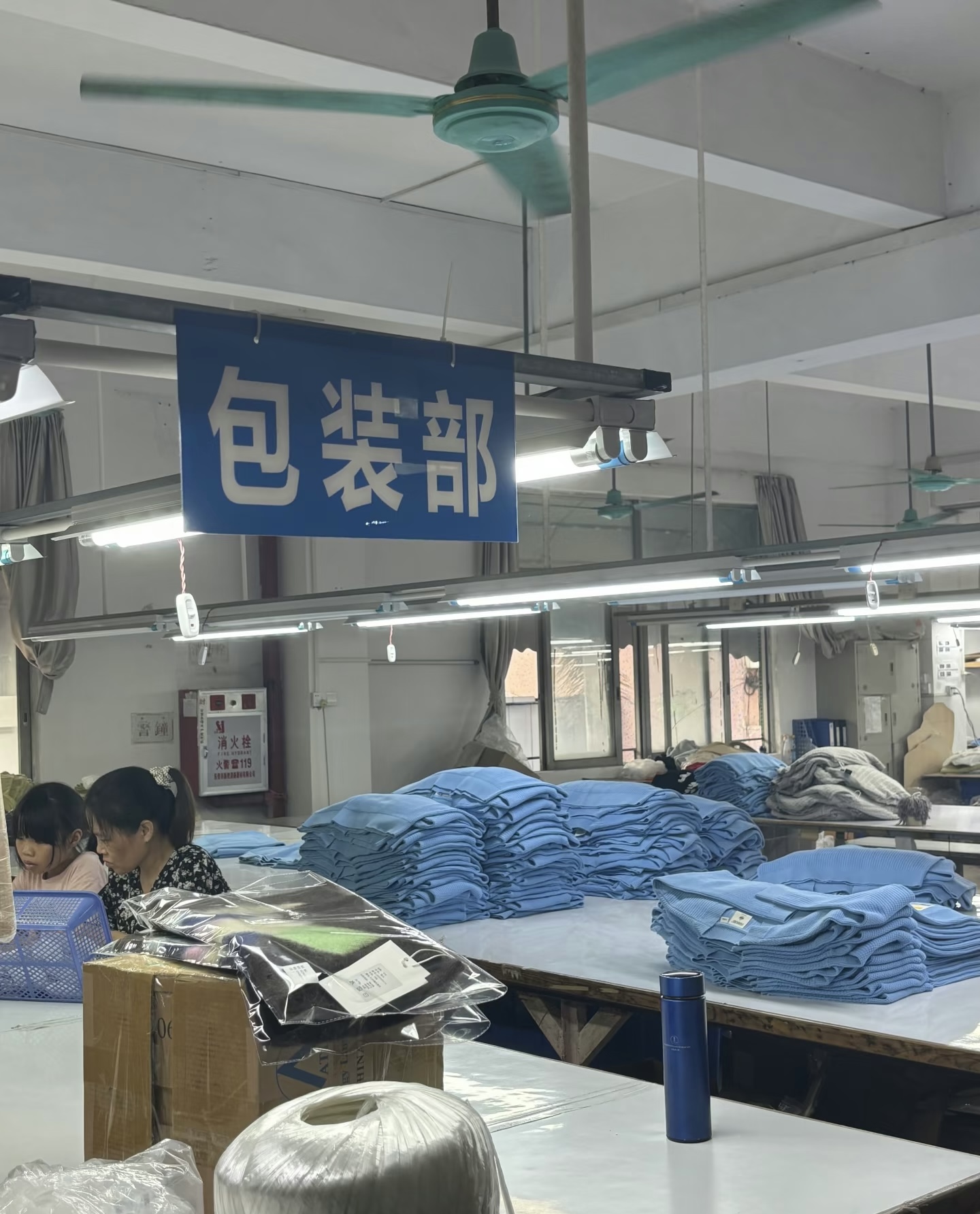 Packing & Shipping — packing department folding and boxing finished knitwear for export