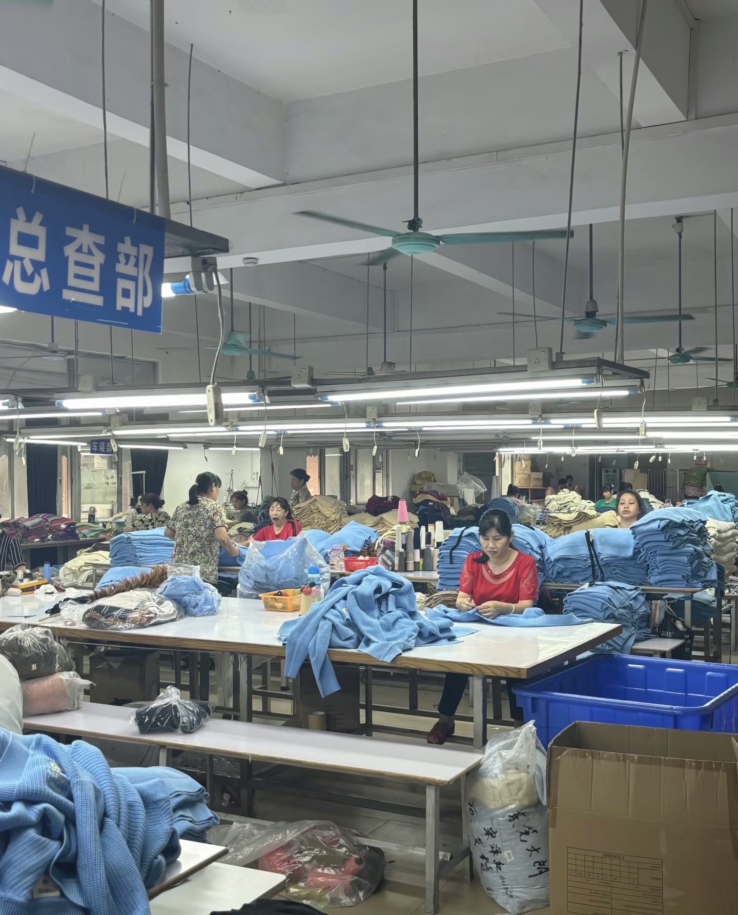 QC Inspection — final check department inspecting finished knitwear before packing